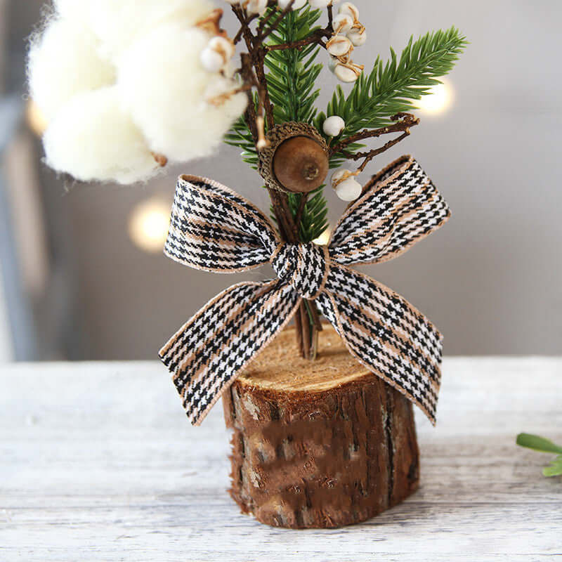 Rustic mini tree table decor with pine sprig, cotton flower, acorn, and plaid ribbon bow
