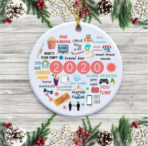 Round 2020-themed holiday ornament with pandemic icons, festive pinecone and berry background.