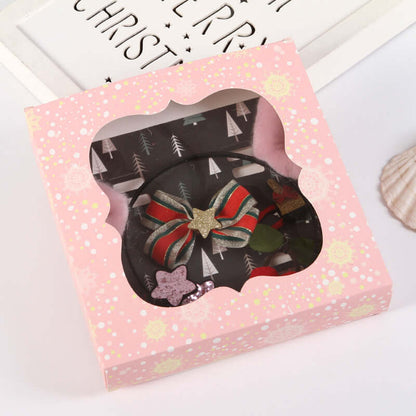 Christmas themed hair accessories gift box with festive bow and star in pink packaging