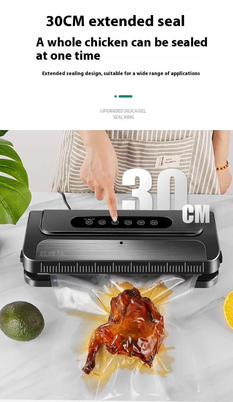 Vacuum sealer sealing a whole cooked chicken in a 30cm wide bag on a kitchen counter