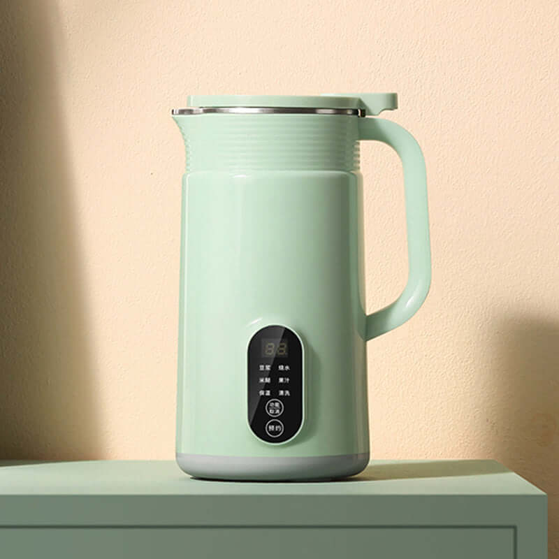 Modern mint green electric kettle with handle and digital control panel on a kitchen counter