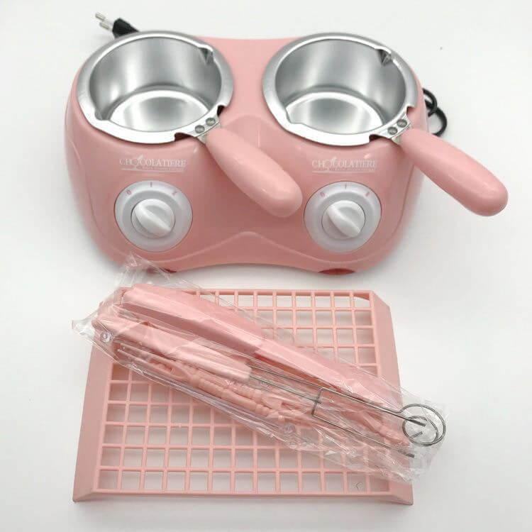 Pink double electric chocolate melting pot with utensils and silicone mat for kitchen use
