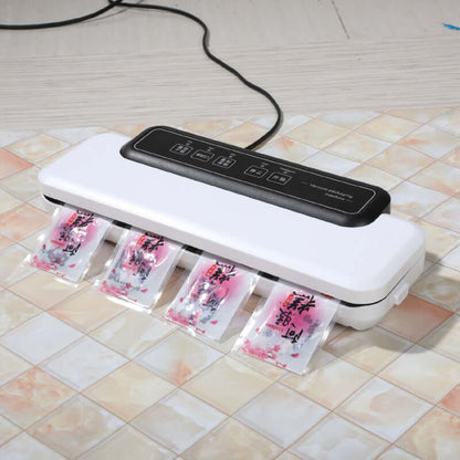 Kitchen vacuum sealer sealing multiple food bags on countertop