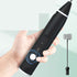 Hand holding electric milk frother with stainless steel whisk attachment