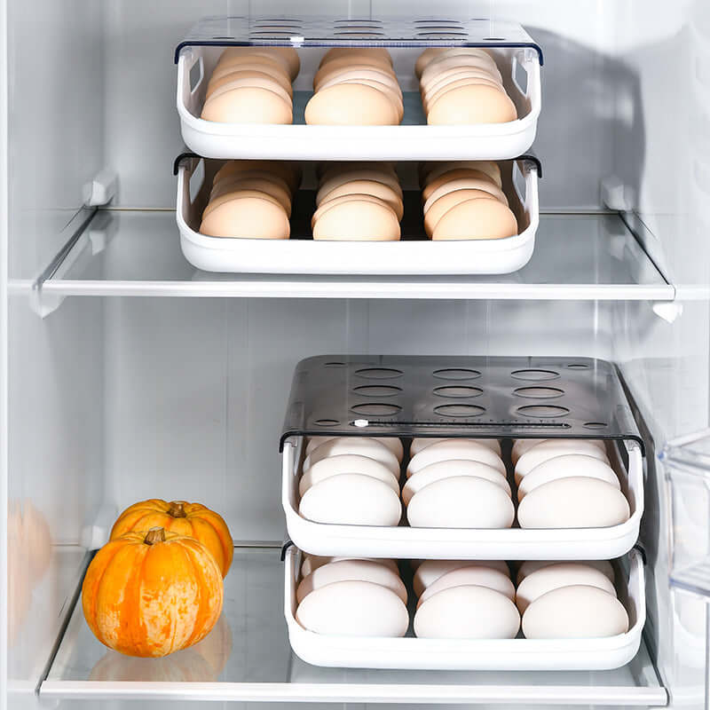 Stackable plastic egg holders in a refrigerator with pumpkins on the shelf