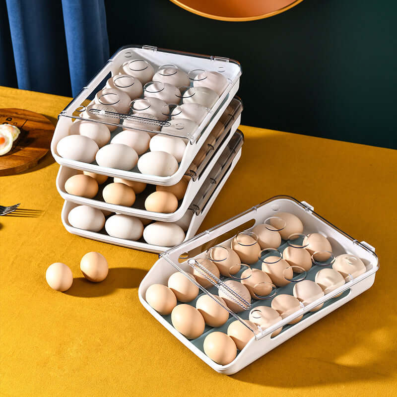 Stackable plastic egg storage containers with lids holding eggs on a kitchen table