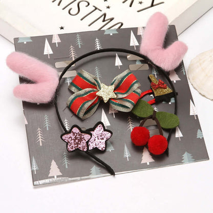 Festive hair accessories set with pink plush headband, star glitter clips, ribbon bow, and cherry pom-poms on a holiday-themed background