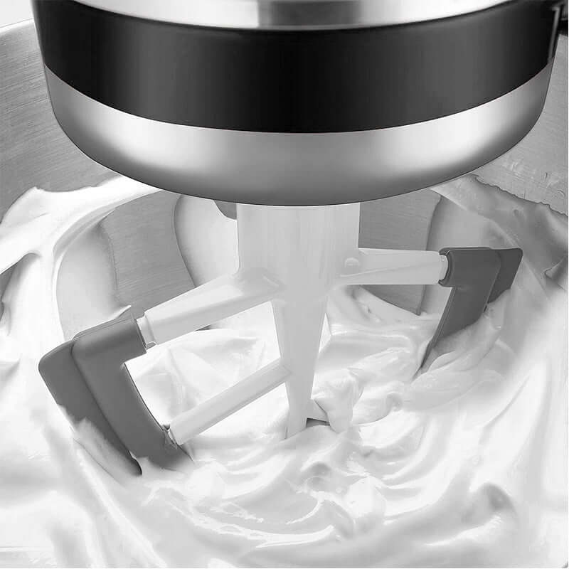 Stand mixer paddle attachment mixing creamy batter in stainless steel bowl