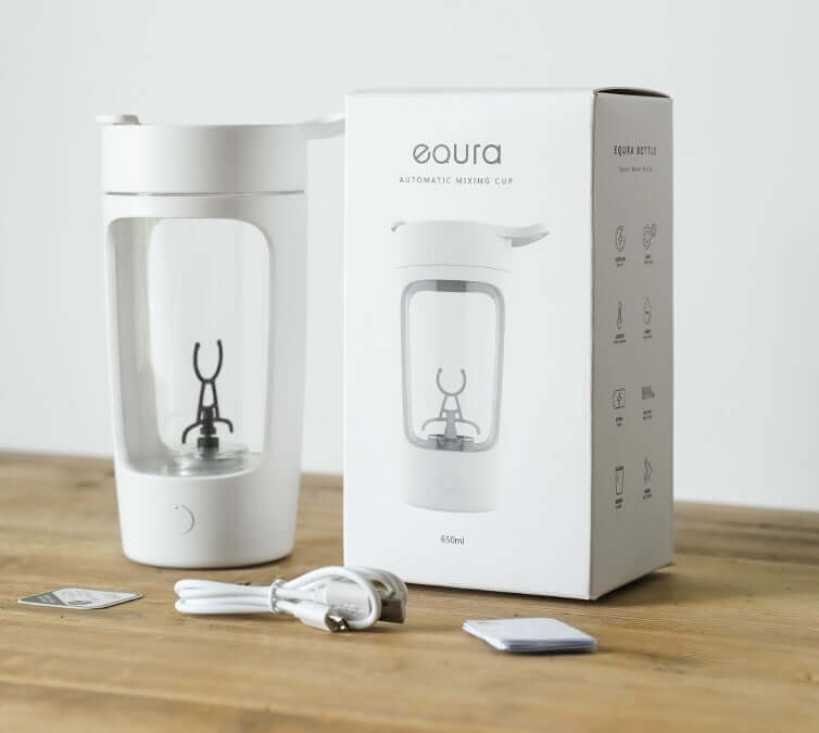 Automatic mixing cup with box, USB cable, and accessories on wooden table