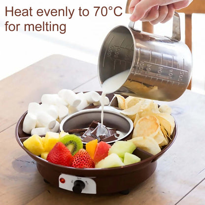 Electric chocolate fondue pot for melting, surrounded by fruit, marshmallows, and chips.