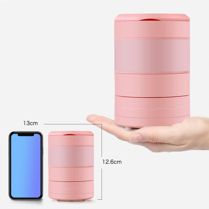 Compact pink kitchen container with stackable layers, shown with hand and smartphone for size reference