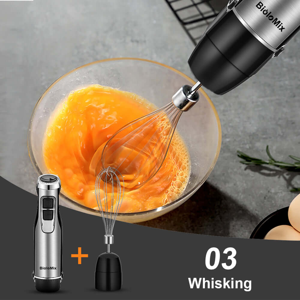 Electric hand mixer whisking eggs in a glass bowl, detachable whisk attachment shown