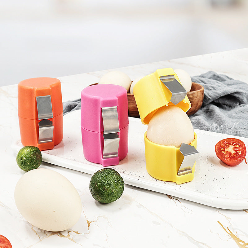 Colorful egg crackers with stainless steel clips on kitchen counter next to eggs and vegetables.