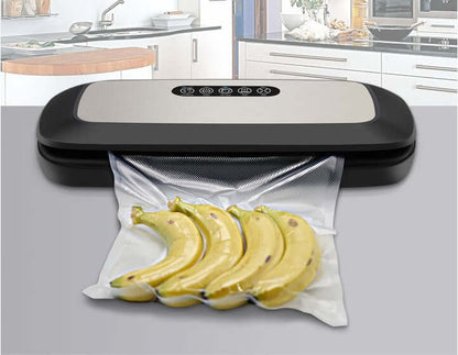Vacuum sealer machine sealing fresh bananas in plastic bag on modern kitchen counter