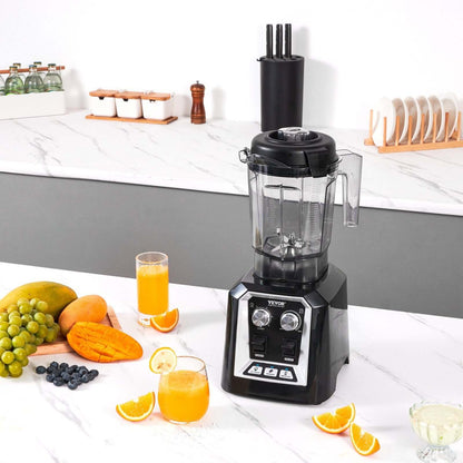 Black countertop blender with fruit and juice on a modern kitchen counter