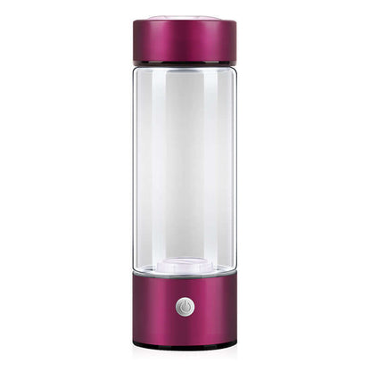 Portable electric blender with pink base and lid, kitchen appliance on white background