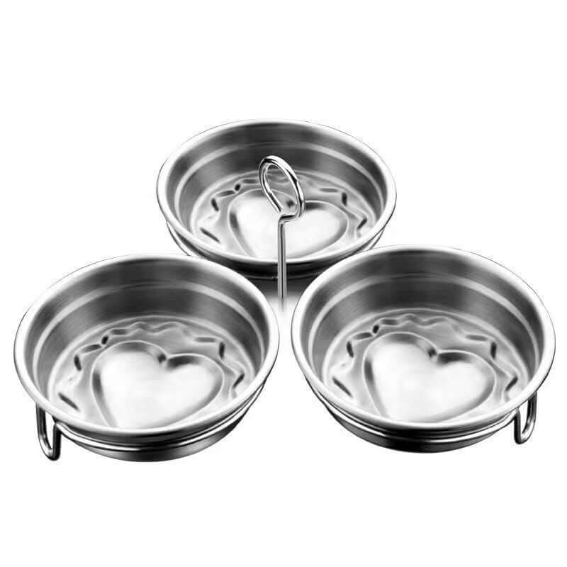 Stainless steel egg poacher cups with heart-shaped centers, kitchen accessory set
