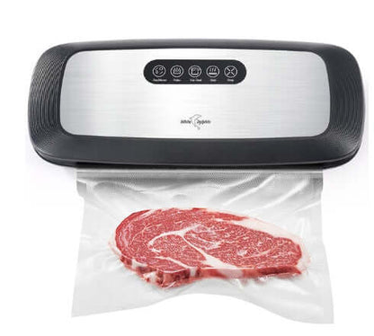 Vacuum sealer machine sealing raw steak in plastic bag for kitchen food storage
