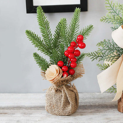 Artificial pine branches with red berries and beige flower in burlap vase for kitchen decor