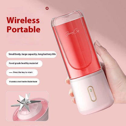 Hand holding wireless portable blender with pink body, stainless steel twelve blade, kitchen accessory