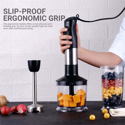 Hand using ergonomic hand blender to chop vegetables, with fresh fruit and kitchen accessories nearby