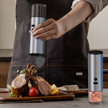 Electric salt and pepper grinder used to season cooked meat in a modern kitchen