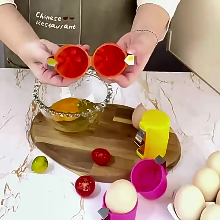 Person using an egg cracker kitchen tool with eggs and bowl on a marble countertop.