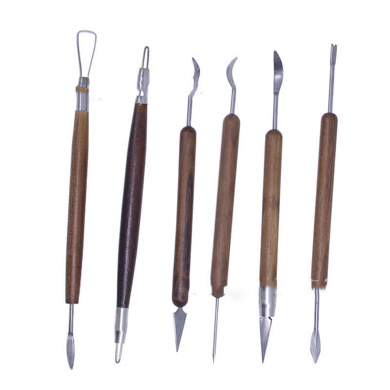 Set of six wooden handle clay sculpting and carving tools on white background