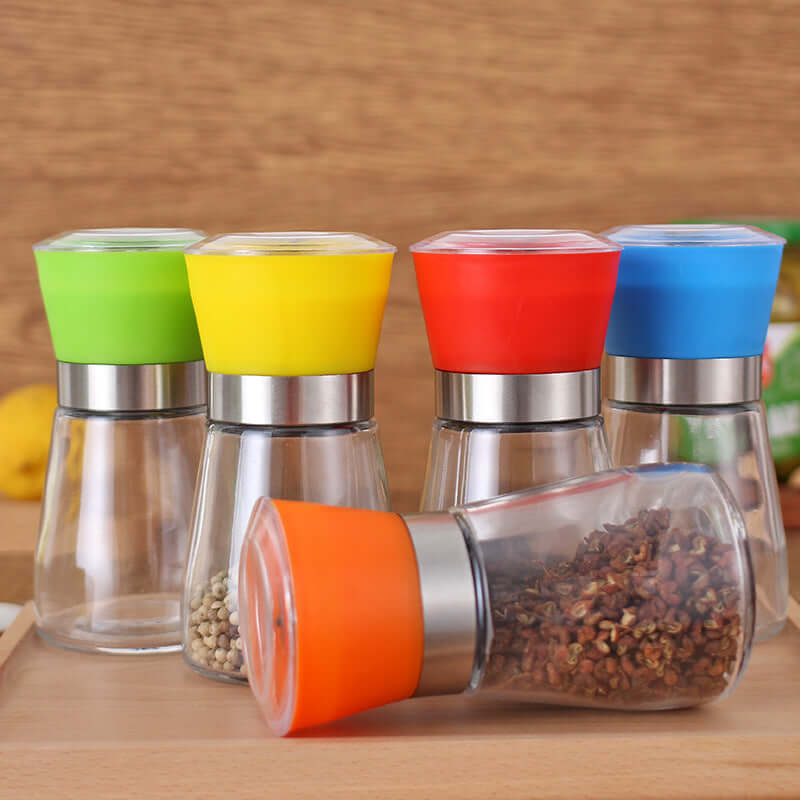 Colorful glass spice grinders with stainless steel, assorted kitchen seasoning containers