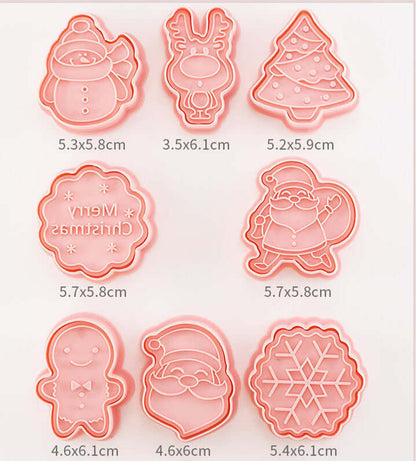 Set of pink Christmas-themed cookie cutters including snowman, reindeer, tree, Santa, and snowflake shapes.