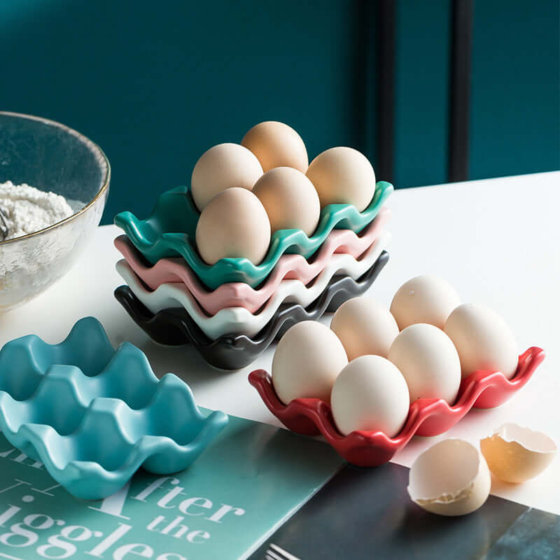 Colorful ceramic egg trays with eggs on a kitchen counter, modern kitchen accessory display