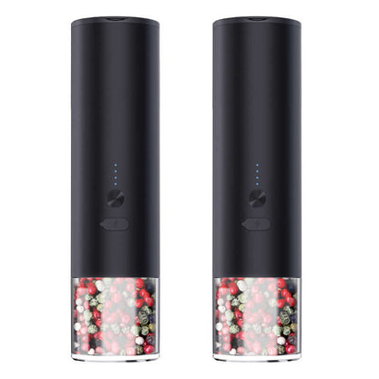 Pair of black electric pepper grinders with visible multi-colored peppercorns