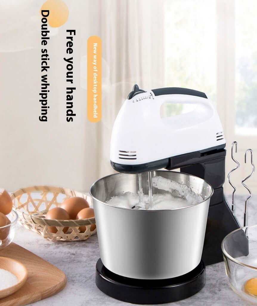 Electric hand mixer with stainless steel mixing bowl whipping eggs on kitchen counter