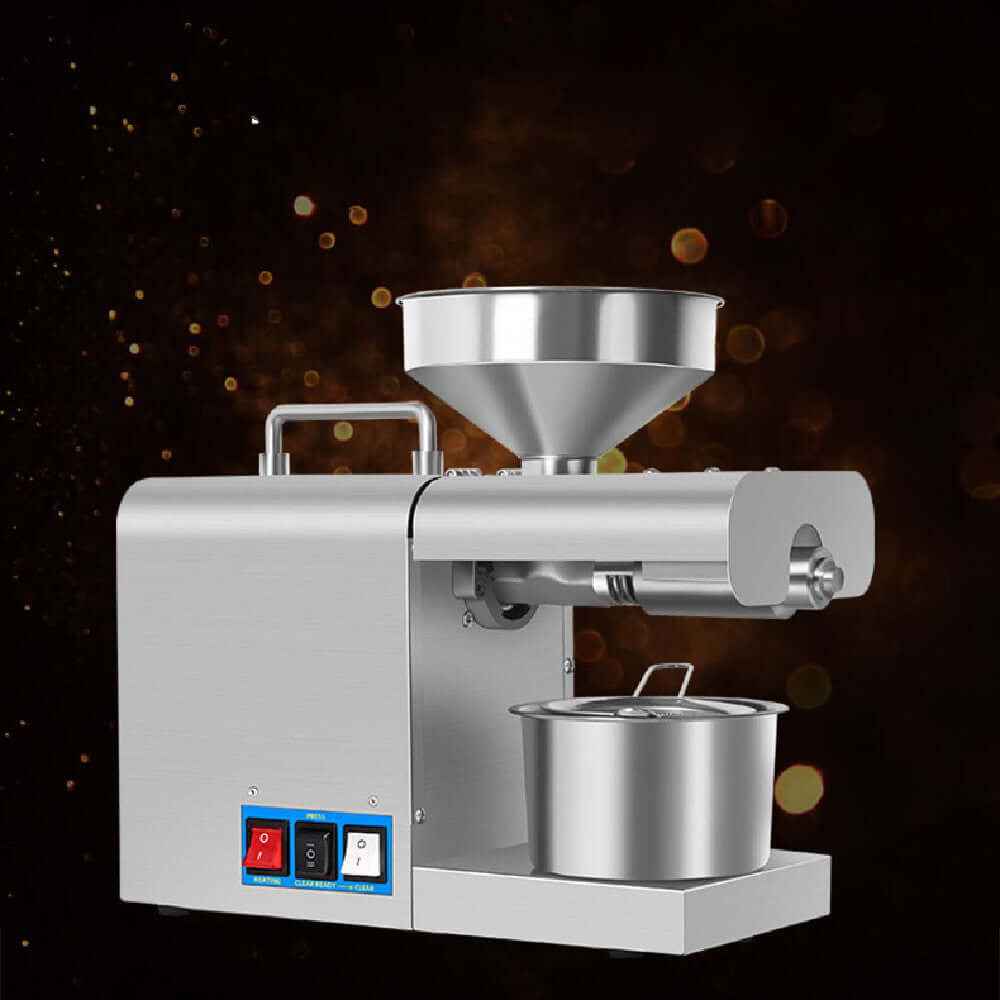 Stainless steel kitchen oil press machine with funnel and control switches on dark background