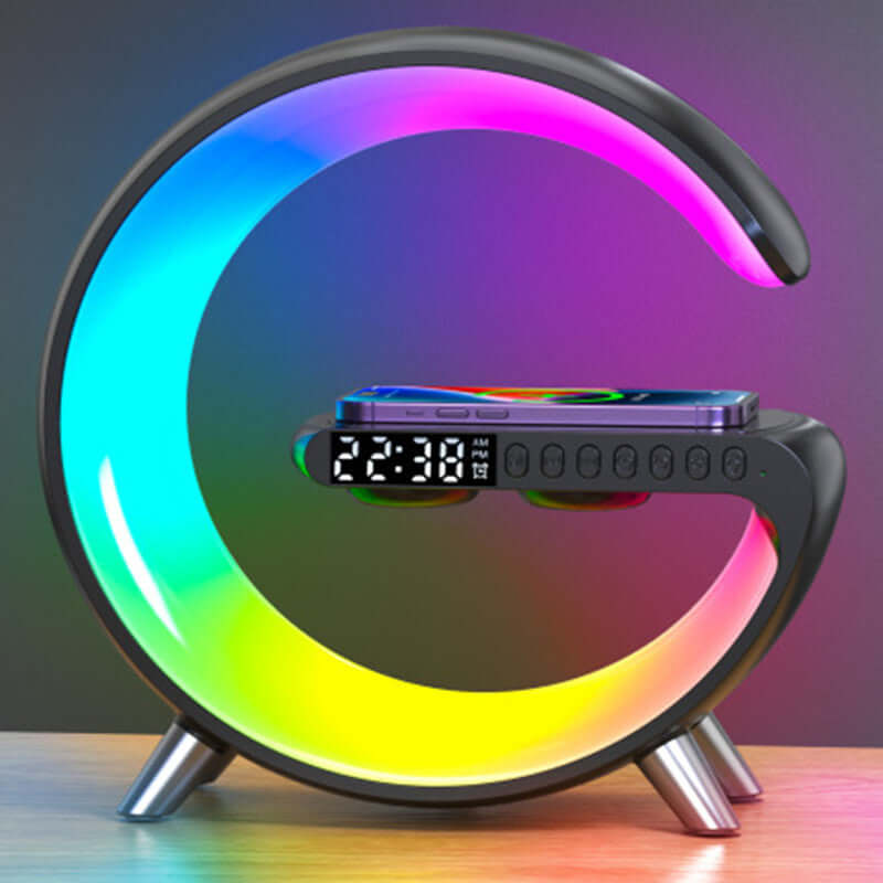 Colorful LED crescent-shaped digital alarm clock with phone wireless charging on wooden table