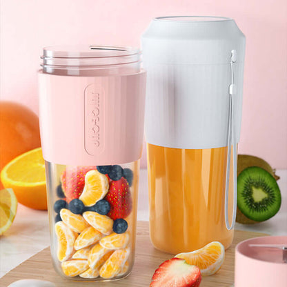 Portable blender cups with fruits and orange juice, kitchen accessories on light background