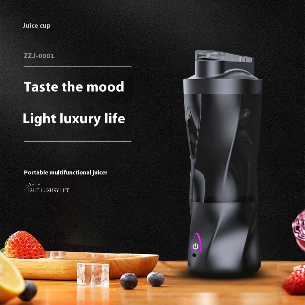 Portable black multifunctional juicer cup on kitchen counter with fruit and ice cubes