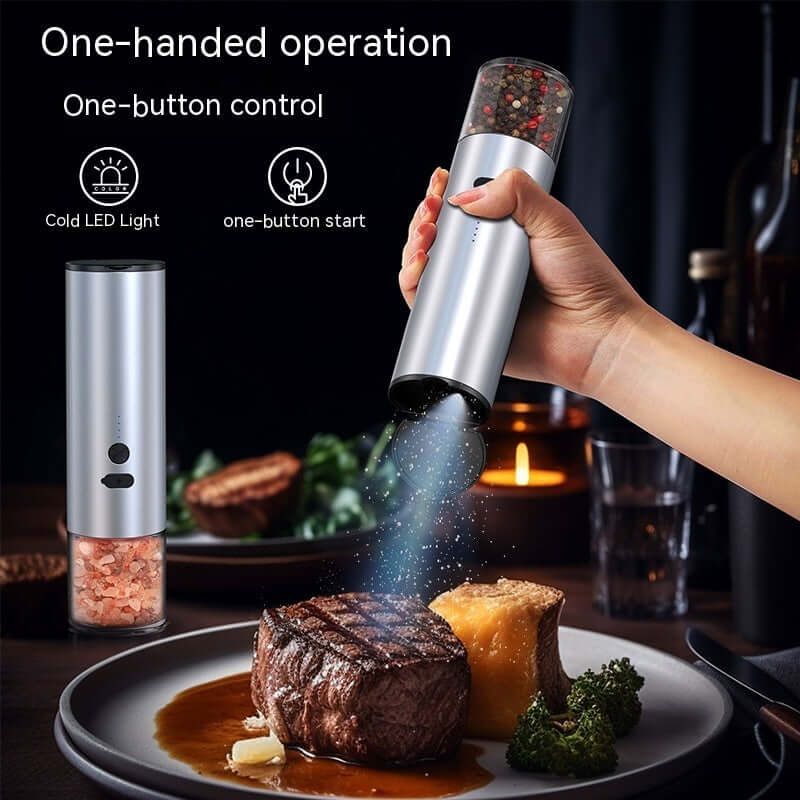 Electric salt and pepper grinder with LED light seasoning steak at dinner table