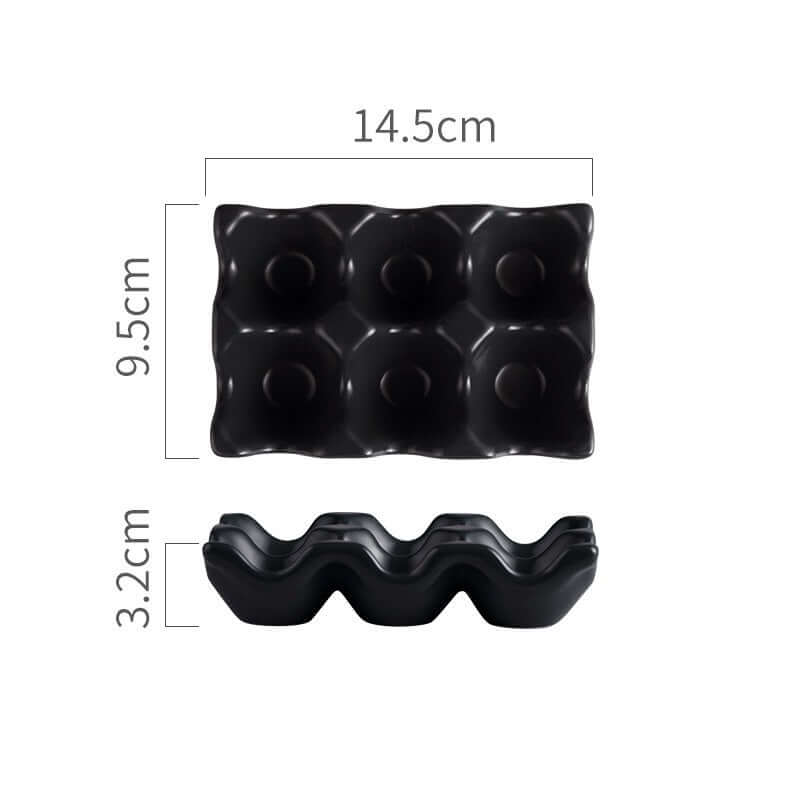 Black plastic egg holder for six eggs with measurements 14.5cm x 9.5cm x 3.2cm
