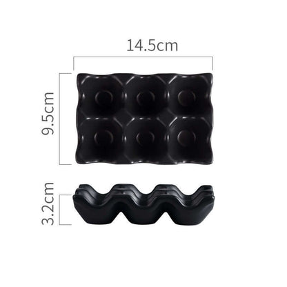 Black plastic egg holder for six eggs with measurements 14.5cm x 9.5cm x 3.2cm