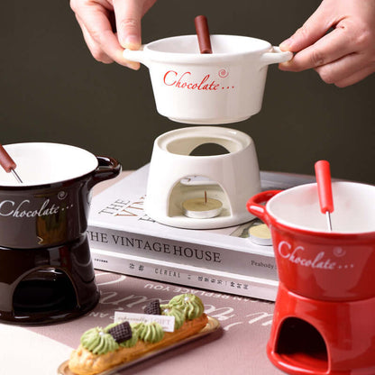 Ceramic chocolate fondue pots with forks and tealight candle, kitchen accessories display