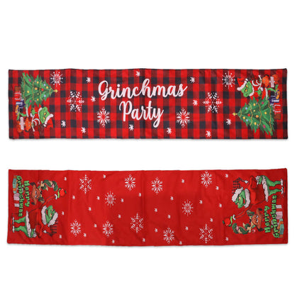 Festive Grinch-themed table runners with Christmas trees, snowflakes, and party text