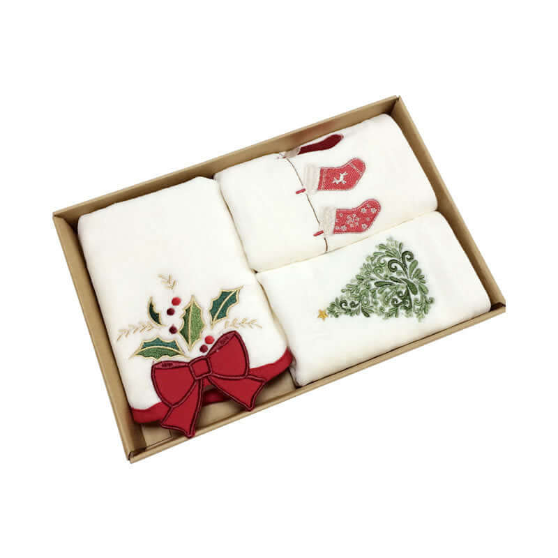 Boxed set of white kitchen towels with Christmas designs, holly, stockings, and tree embroidery