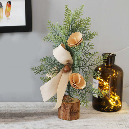 Artificial mini pine tree with beige flowers, ribbon, and acorn on wood base for home decor