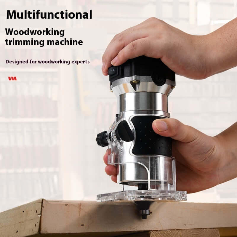 Hand using a multifunctional woodworking trimming machine on a wooden surface