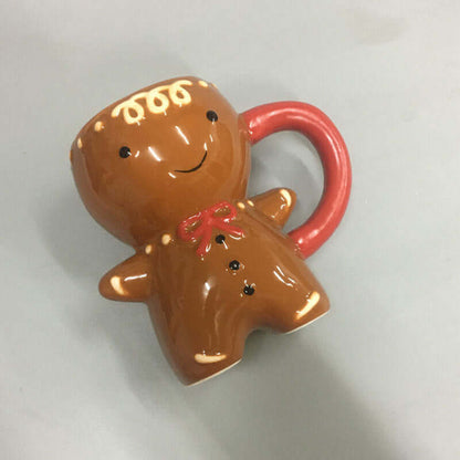 Ceramic gingerbread man mug with red handle and decorative icing details