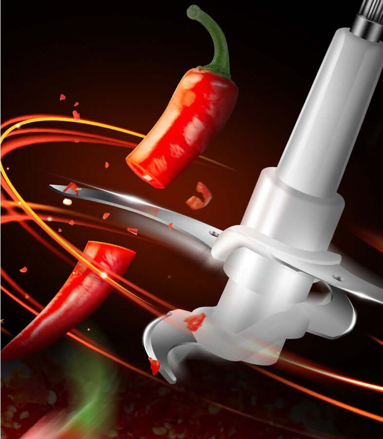 Stainless steel food processor blade chopping red chili pepper, kitchen accessory