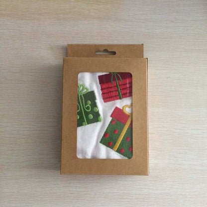 Gift-themed kitchen towel set in brown box with clear window, featuring colorful presents.