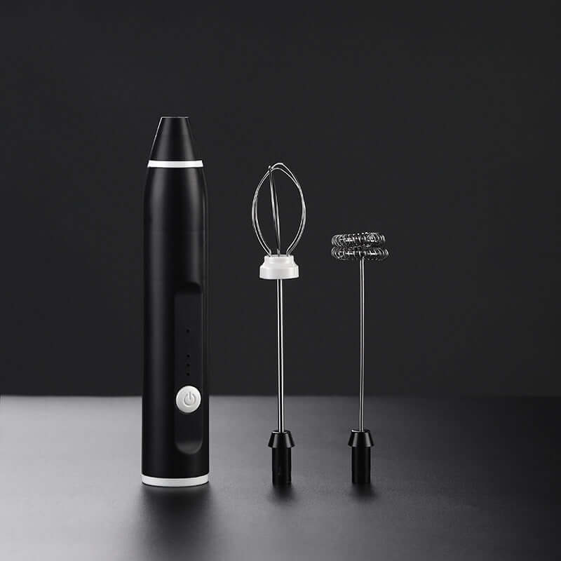 Electric handheld milk frother with whisk and beater attachments on black background