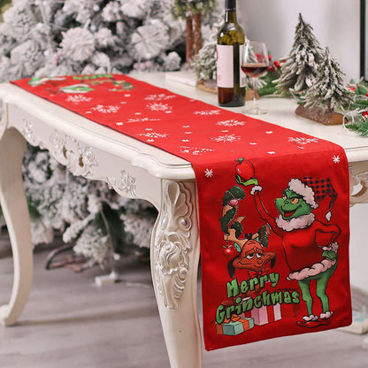 Christmas table runner with green character, red background, and snowflake pattern on dining table